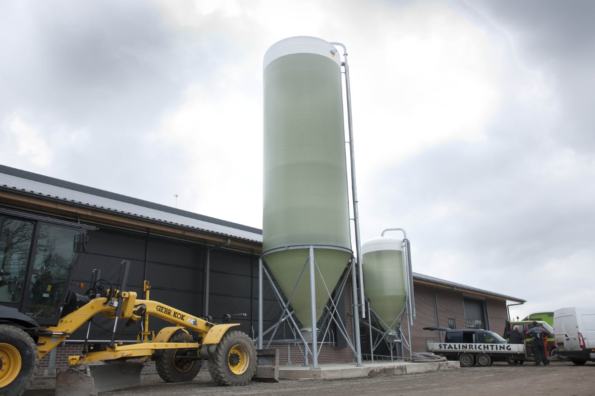 Twee nieuwe krachtvoersilo’s. De linker silo heeft een inhoud van 36 ton en voorziet de melkstal van krachtvoer. De rechtersilo is bedoeld voor de droge koeien in de close-upgroep.